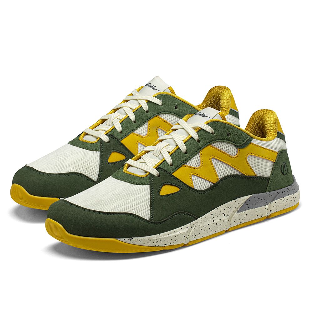 Joe Nimble Addict barfotasko för herr i grön, gul och vit färgkombination. Låg sneaker med bred tåbox, ventilerande ovandel och dämpad sula i stänkmönstrad grå-beige. Designad för naturlig rörelse och optimal komfort vid vardagsanvändning.